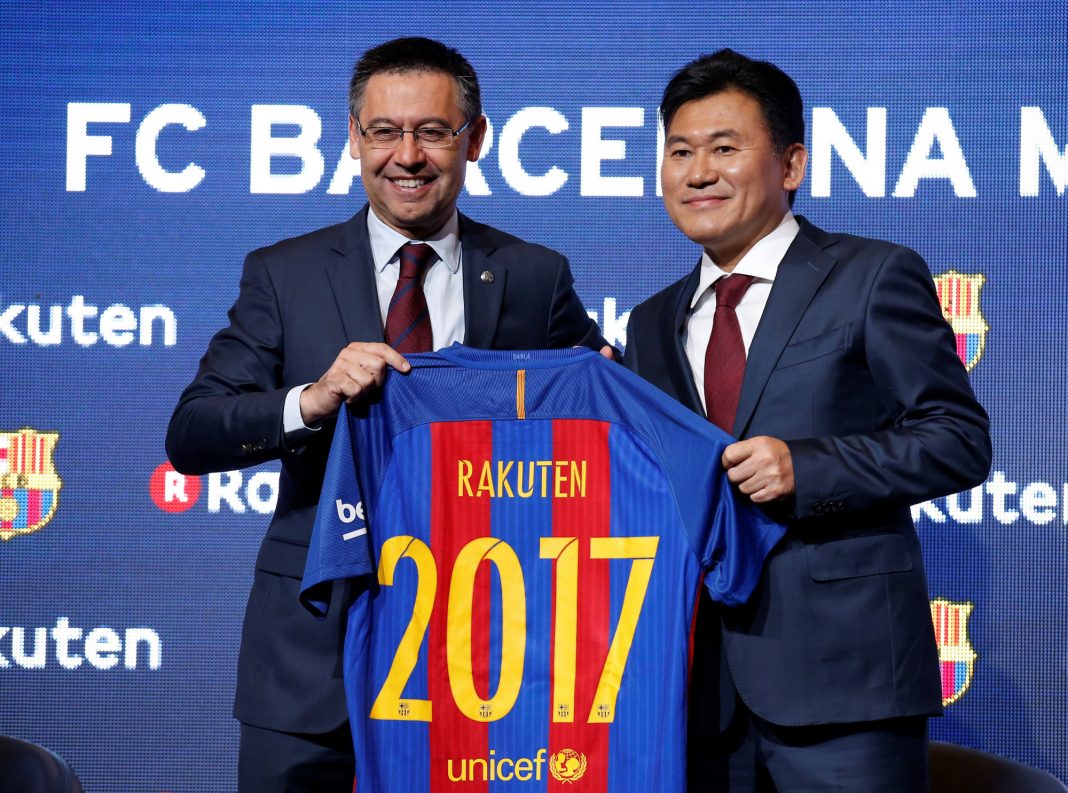 FC Barcelona's President Josep Maria Bartomeu and Rakuten's President with CEO Hiroshi Mikitani pose with a jersey after signing a contract as main sponsor in Barcelona