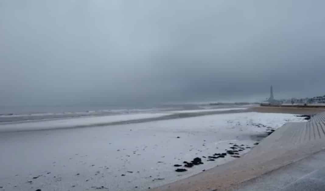 Snow and hail on Blackpool beach (Blackpool Tower barely visible in distance) with dark clouds over the sea. Photos: A Walk on The Wildside
