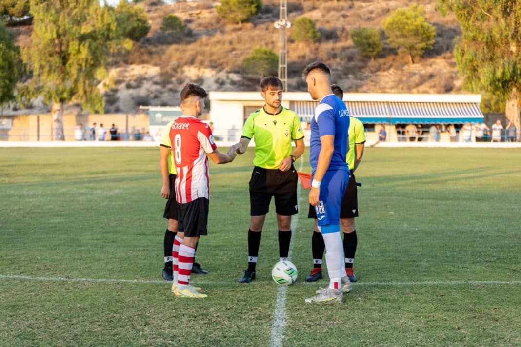 Skipper Juan with match officials prior to the game against Bullense